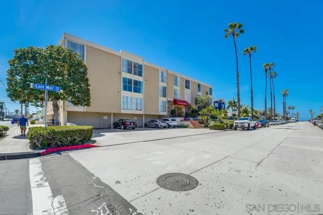 a front view of a house with a yard and potted plants