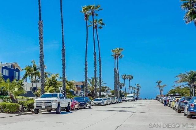 a car parked in front of a building with potted plants