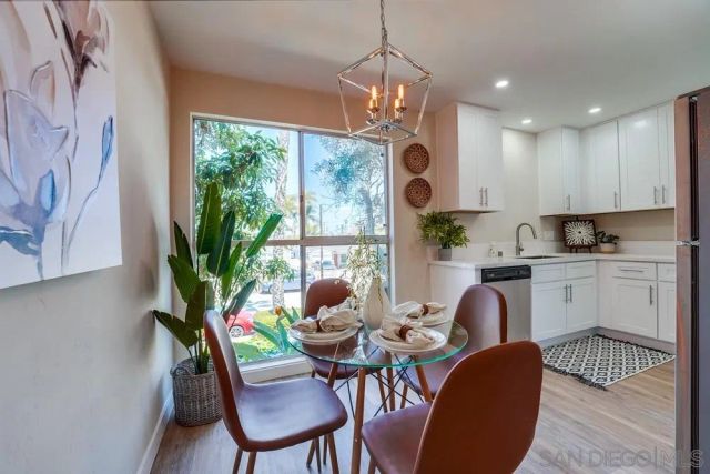 a view of a dining room with furniture a livingroom and chandelier