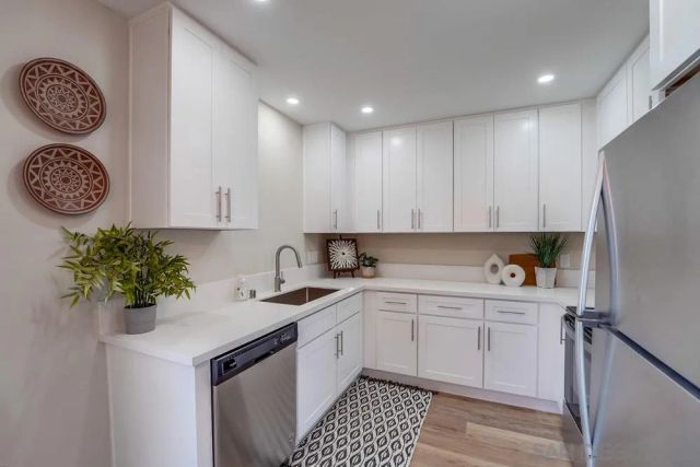 a kitchen with a sink a refrigerator and a stove