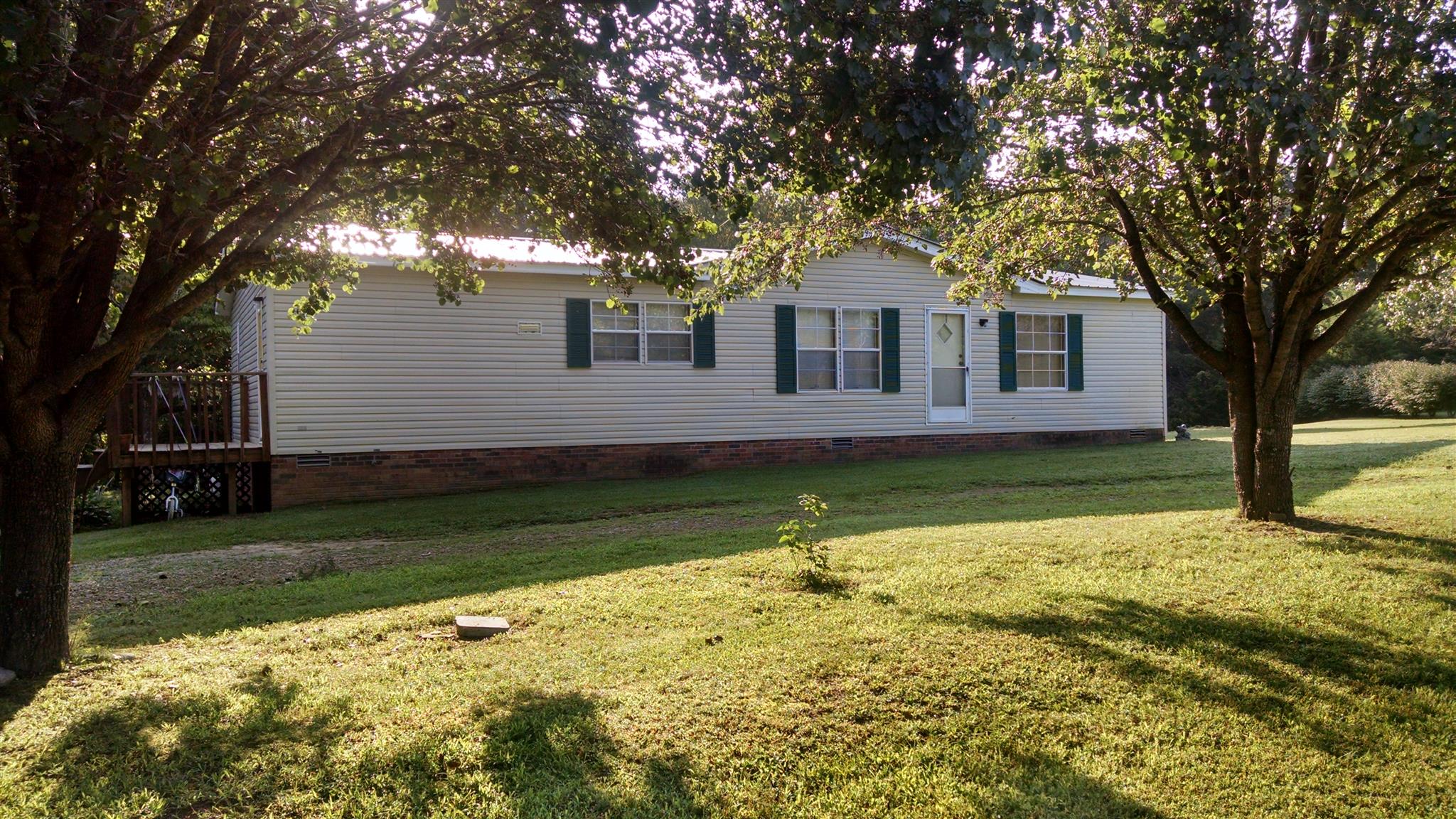 8647 Richards Road Lyles, TN 37098 - Photo 1 of 29 a front view of a house with a yard