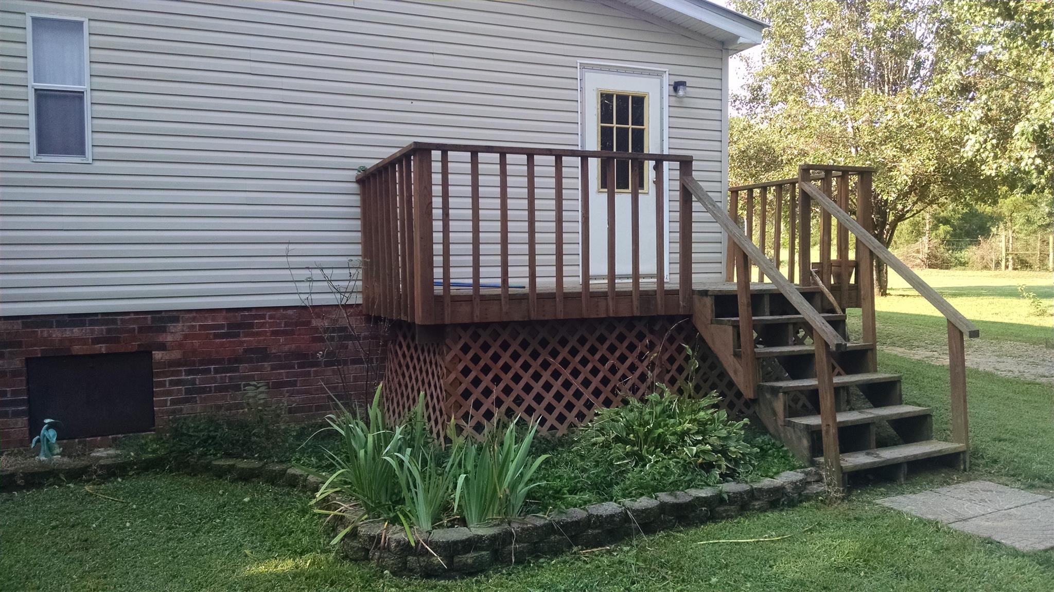 8647 Richards Road Lyles, TN 37098 - Photo 16 of 29 a front view of a house with a garden