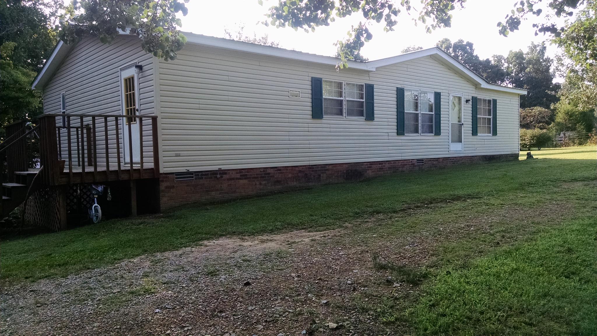 8647 Richards Road Lyles, TN 37098 - Photo 17 of 29 a front view of a house with a garden