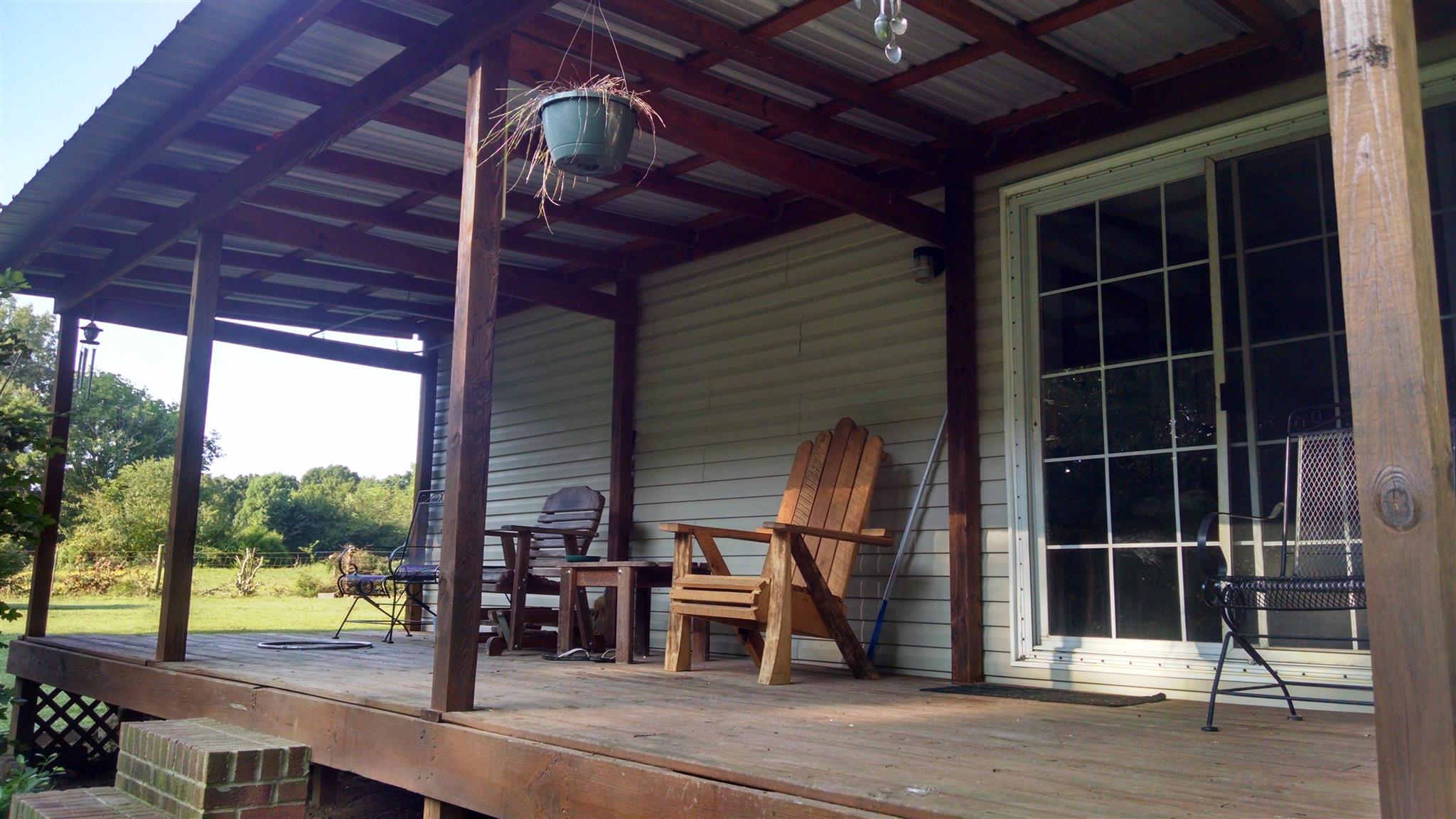 8647 Richards Road Lyles, TN 37098 - Photo 18 of 29 a view of a porch with wooden floor and iron stairs