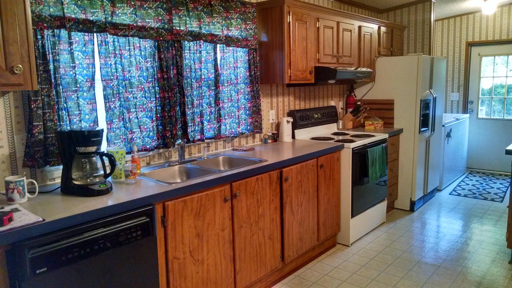 8647 Richards Road Lyles, TN 37098 - Photo 19 of 29 a kitchen with stainless steel appliances granite countertop a sink stove and refrigerator