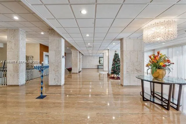 a lobby with furniture and floor to ceiling window
