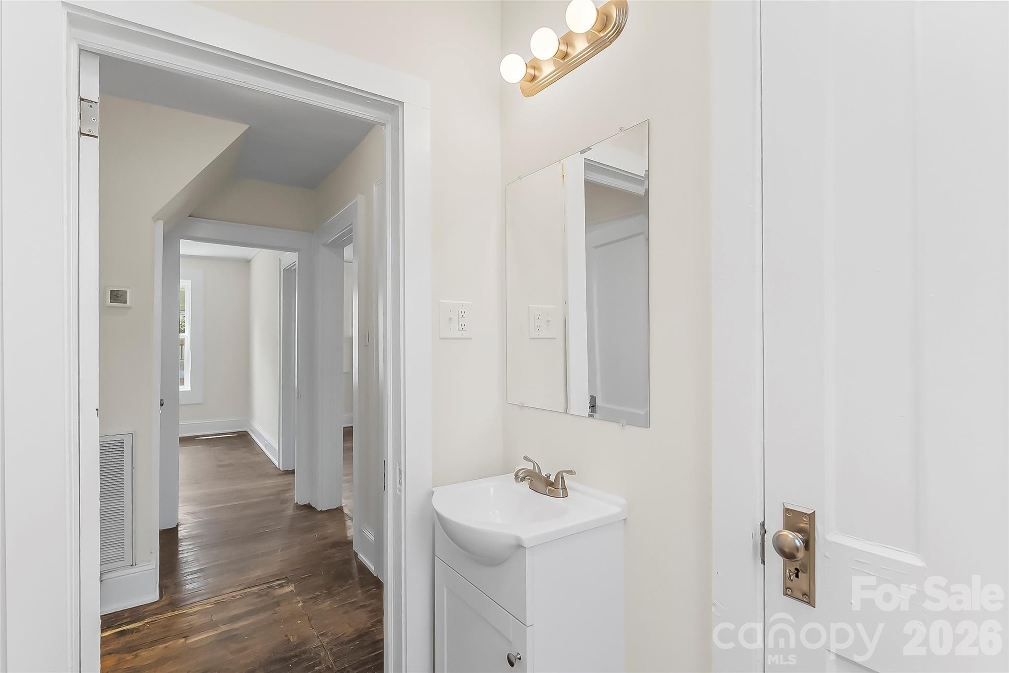 608 East Concord Street Morganton, NC 28655 - Photo 11 of 23 a bathroom with a sink and a mirror