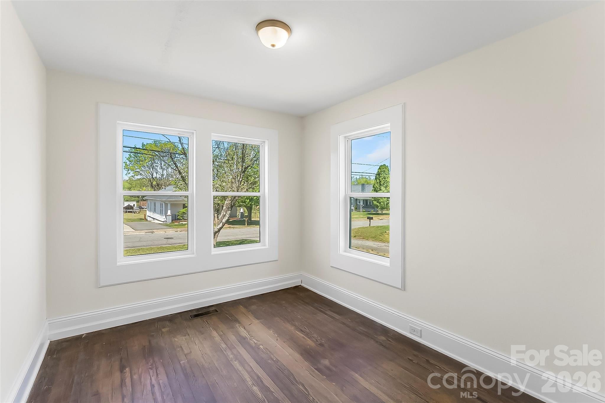 608 East Concord Street Morganton, NC 28655 - Photo 13 of 23 an empty room with wooden floor and windows