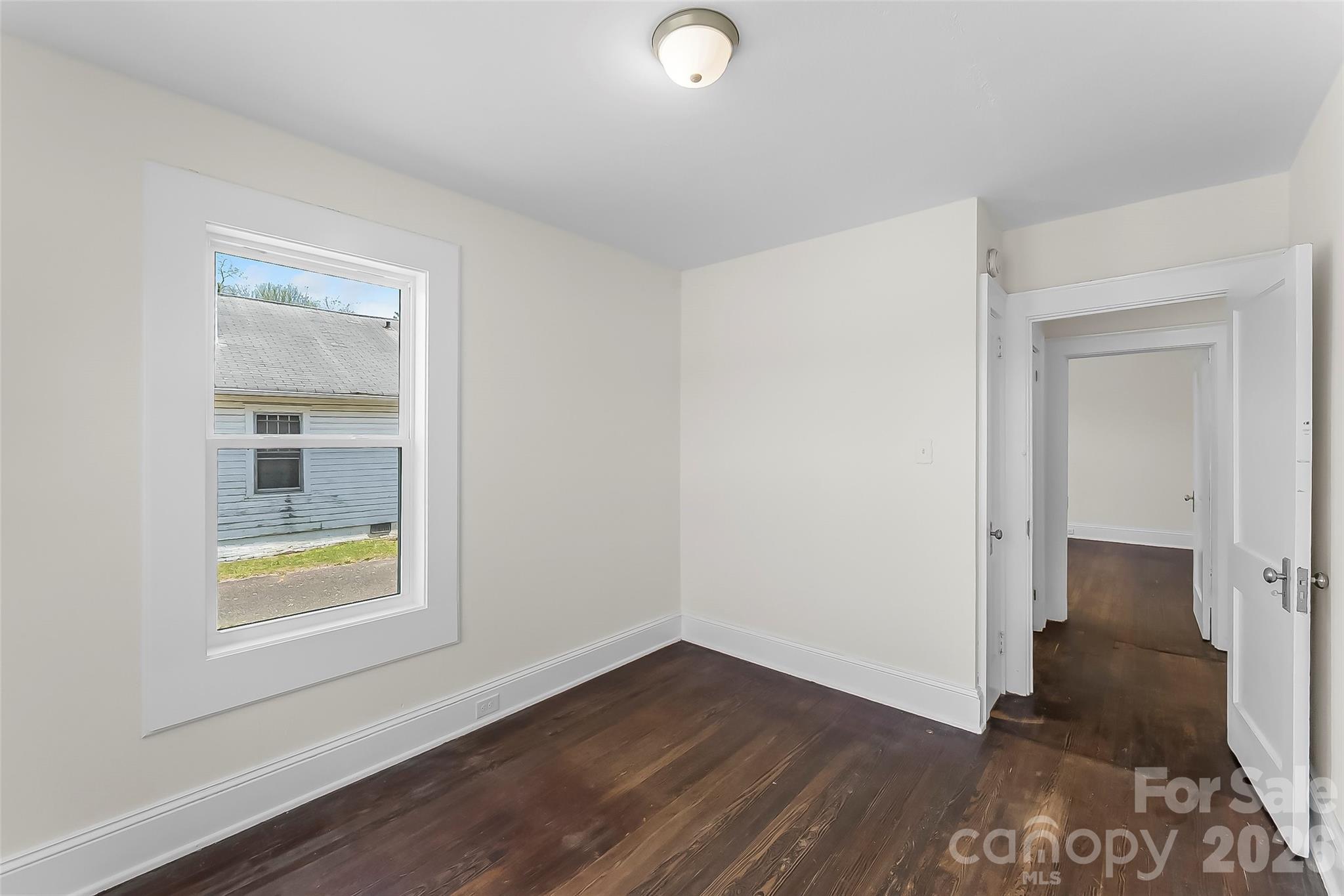 608 East Concord Street Morganton, NC 28655 - Photo 14 of 23 an empty room with wooden floor and windows