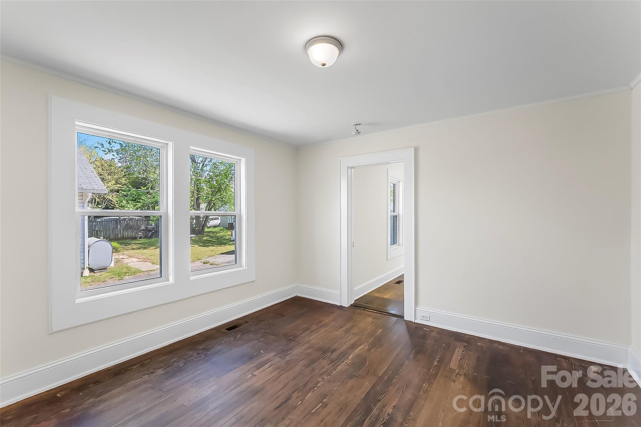 608 East Concord Street Morganton, NC 28655 - Photo 16 of 23 an empty room with wooden floor and windows
