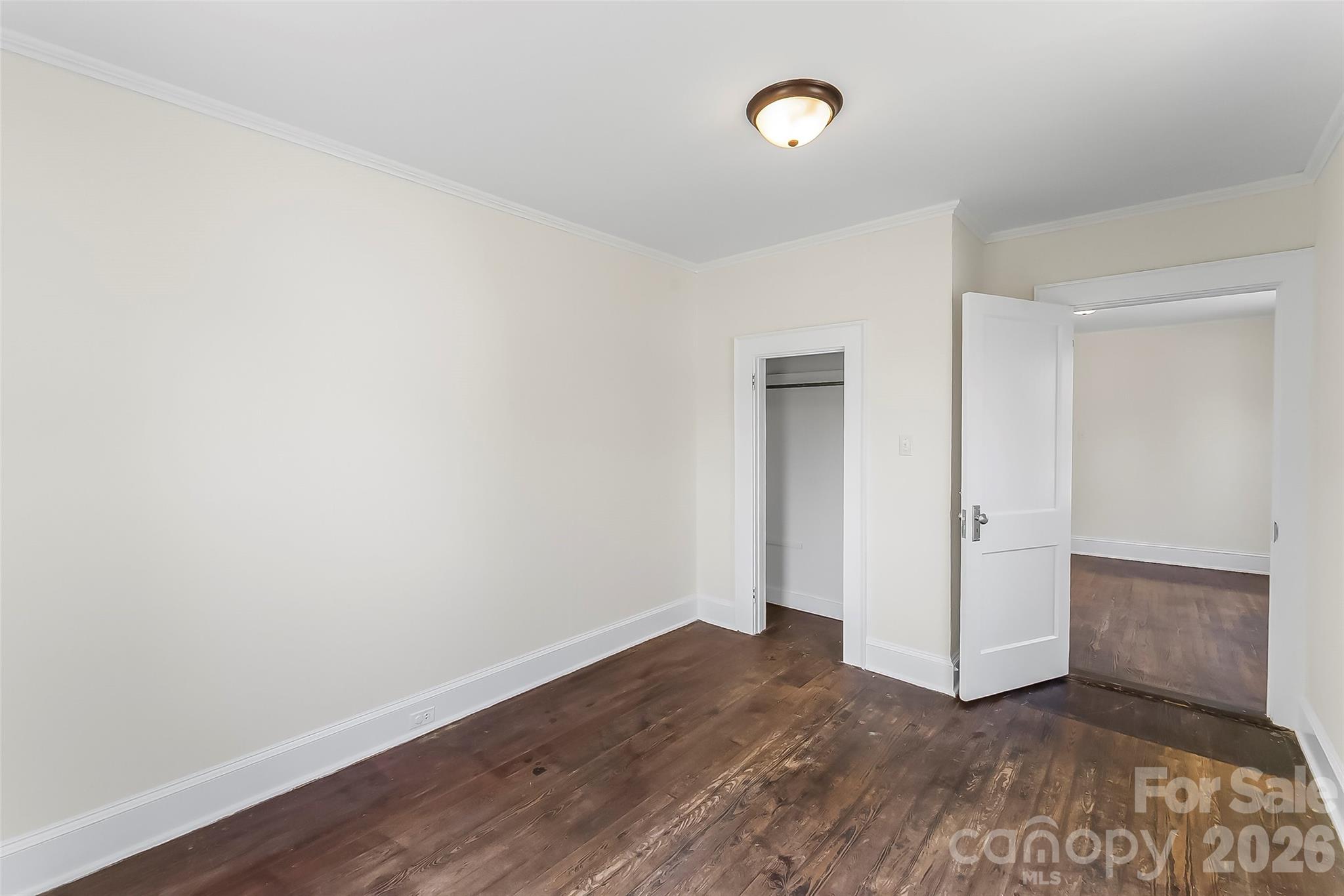 608 East Concord Street Morganton, NC 28655 - Photo 17 of 23 an empty room with wooden floor and windows