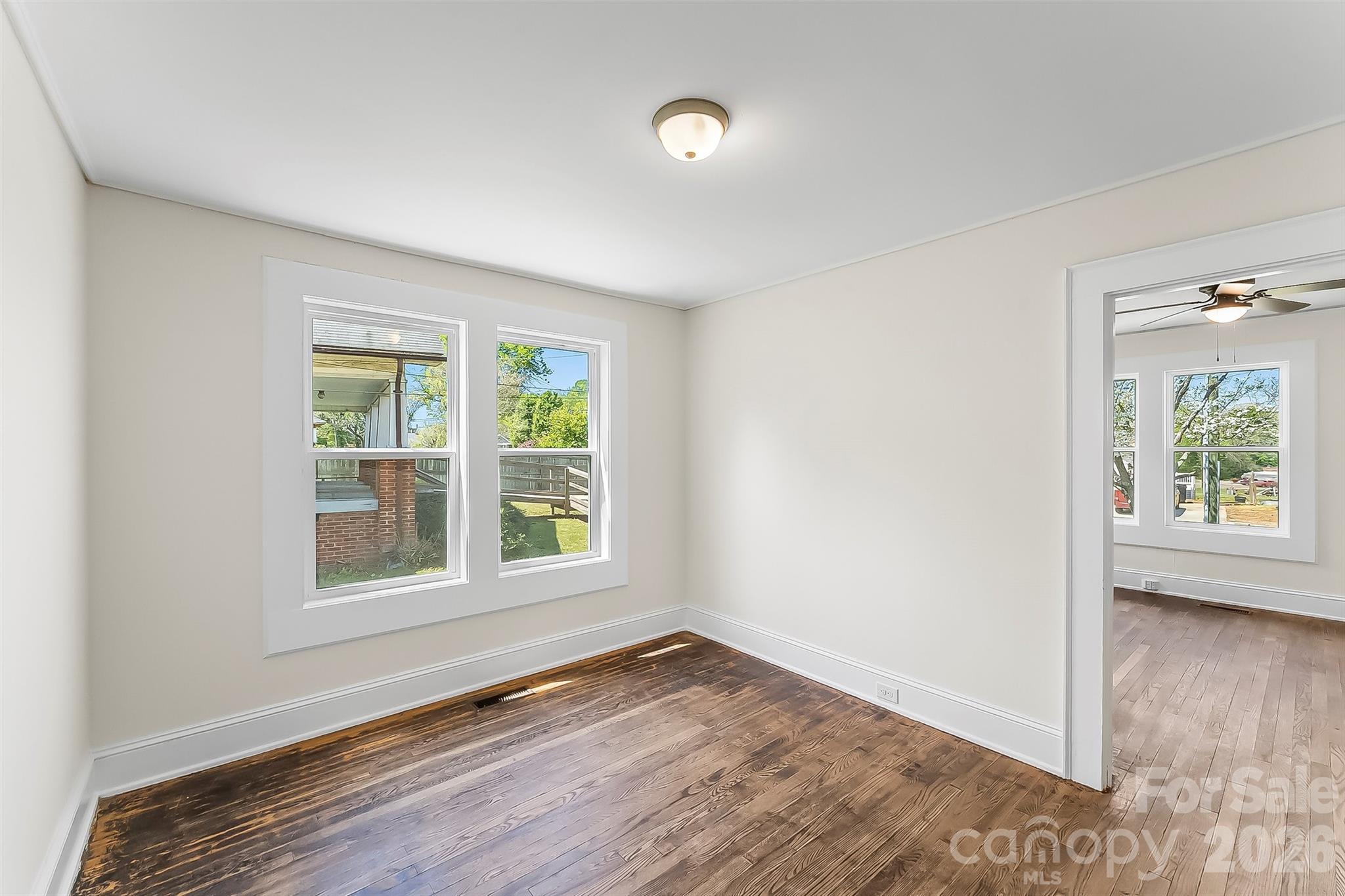 608 East Concord Street Morganton, NC 28655 - Photo 6 of 23 an empty room with wooden floor and windows