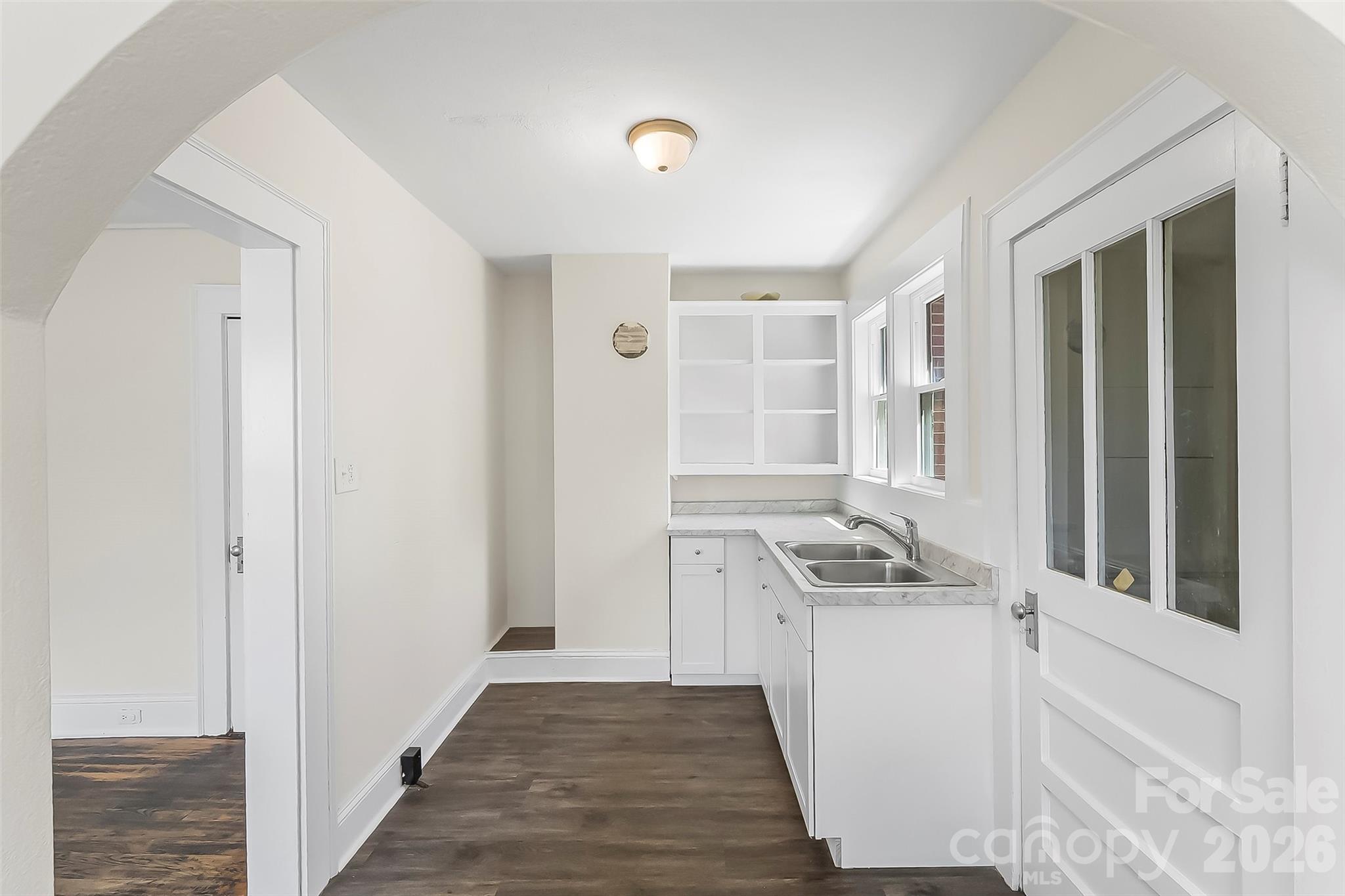 608 East Concord Street Morganton, NC 28655 - Photo 7 of 23 a kitchen with granite countertop a sink and a refrigerator