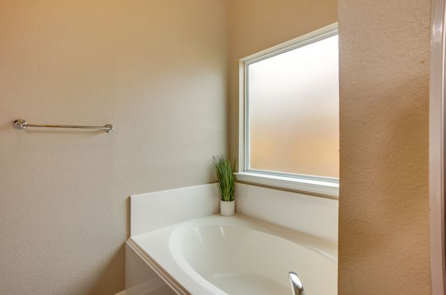 2105 Granite Ridge Place Bryan, TX 77801 - Photo 15 of 23 a bathroom with a bathtub