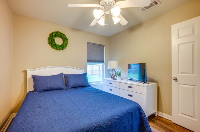 2105 Granite Ridge Place Bryan, TX 77801 - Photo 17 of 23 a bedroom with a bed and a chandelier