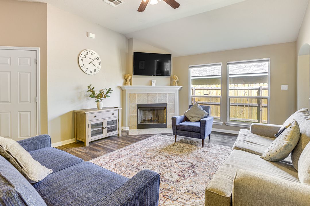 2105 Granite Ridge Place Bryan, TX 77801 - Photo 4 of 23 a living room with furniture a flat screen tv and a fireplace