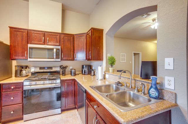 2105 Granite Ridge Place Bryan, TX 77801 - Photo 8 of 23 a kitchen with granite countertop a sink stove and cabinets