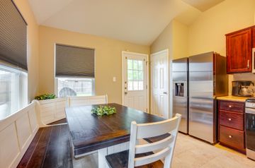 2105 Granite Ridge Place Bryan, TX 77801 - Photo 10 of 23 a kitchen with a table chairs refrigerator and microwave