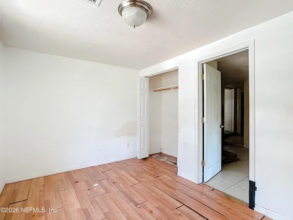 an empty room with windows and closet