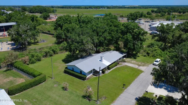 an aerial view of a house with a yard