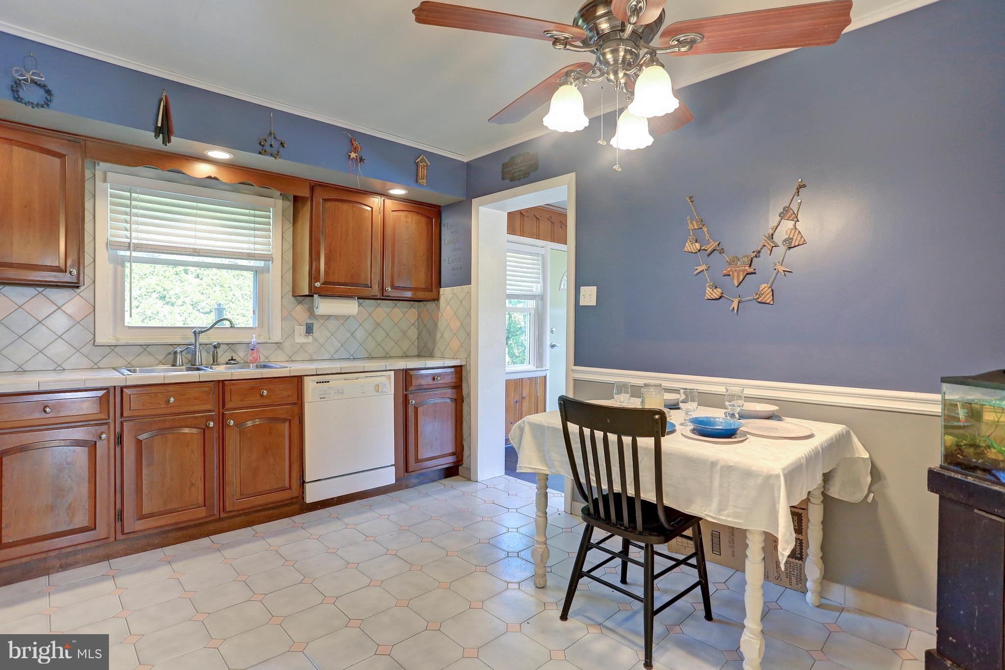 425 Corbin Road York, PA 17403 - Photo 11 of 49 a kitchen with granite countertop a table chairs a sink dishwasher refrigerator and cabinets