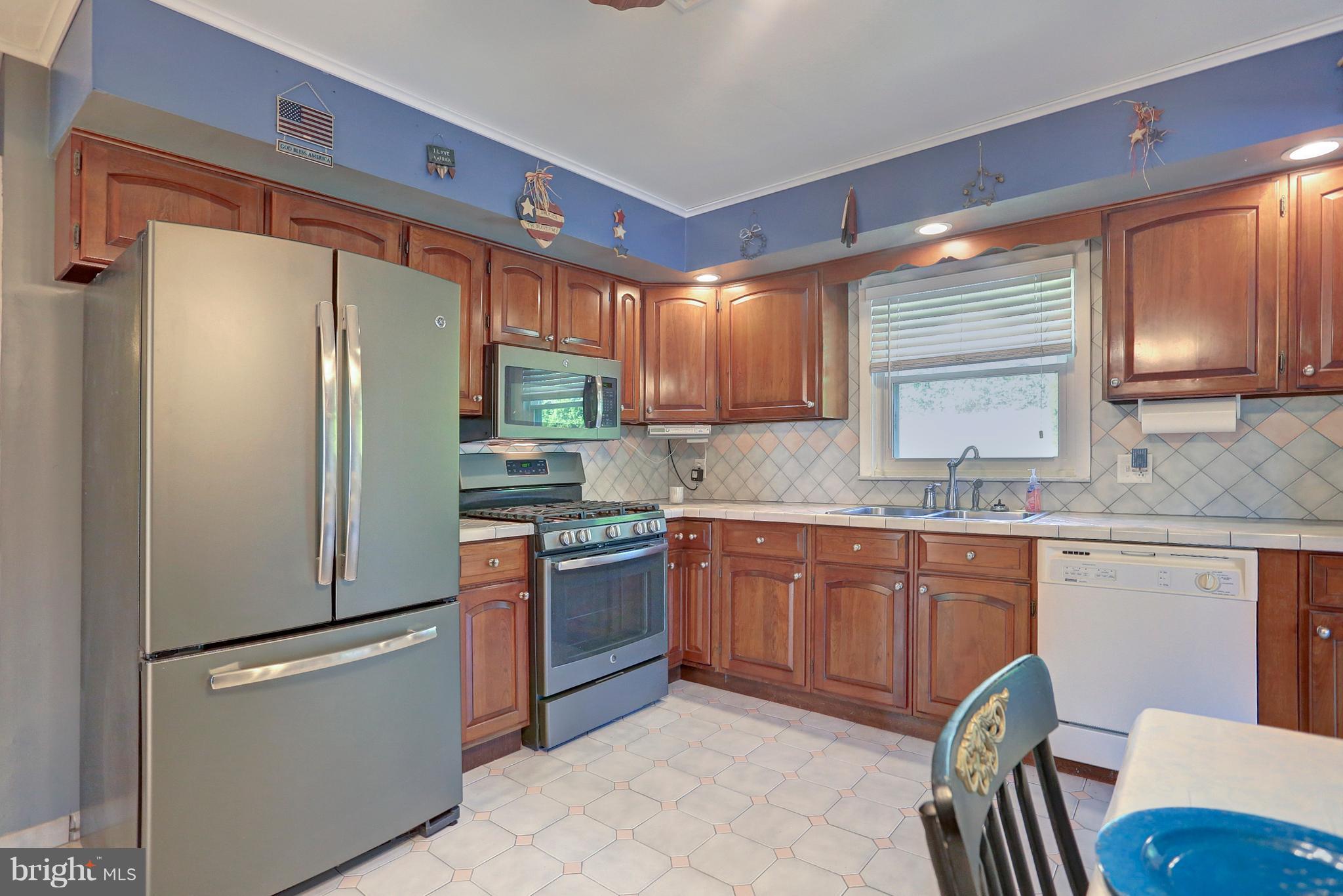 425 Corbin Road York, PA 17403 - Photo 12 of 49 a kitchen with stainless steel appliances granite countertop a refrigerator a stove a sink a dining table and chairs