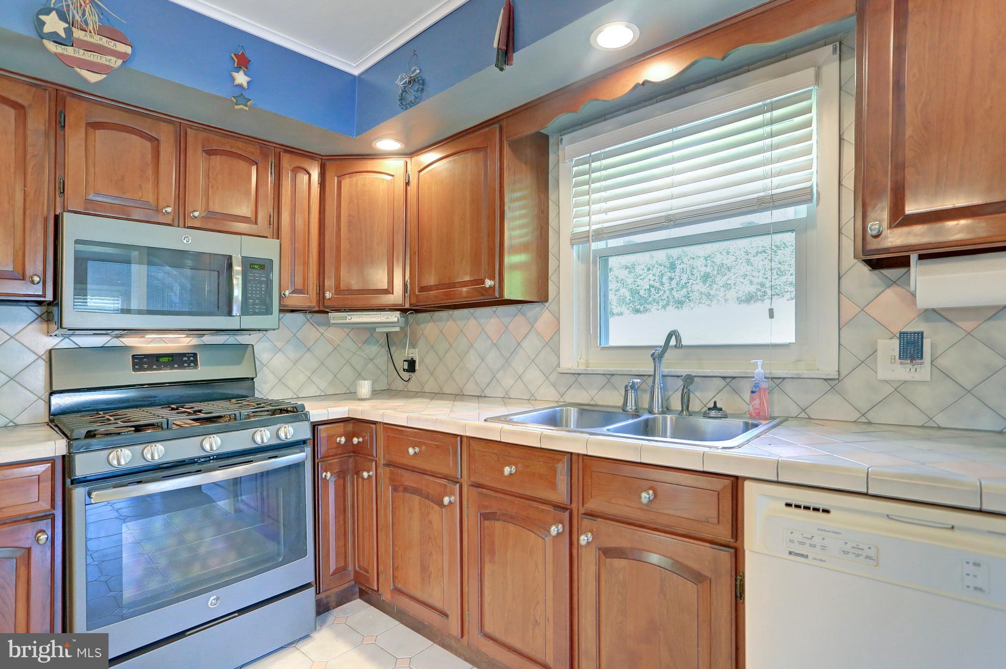425 Corbin Road York, PA 17403 - Photo 13 of 49 a kitchen with granite countertop cabinets stainless steel appliances a sink and window