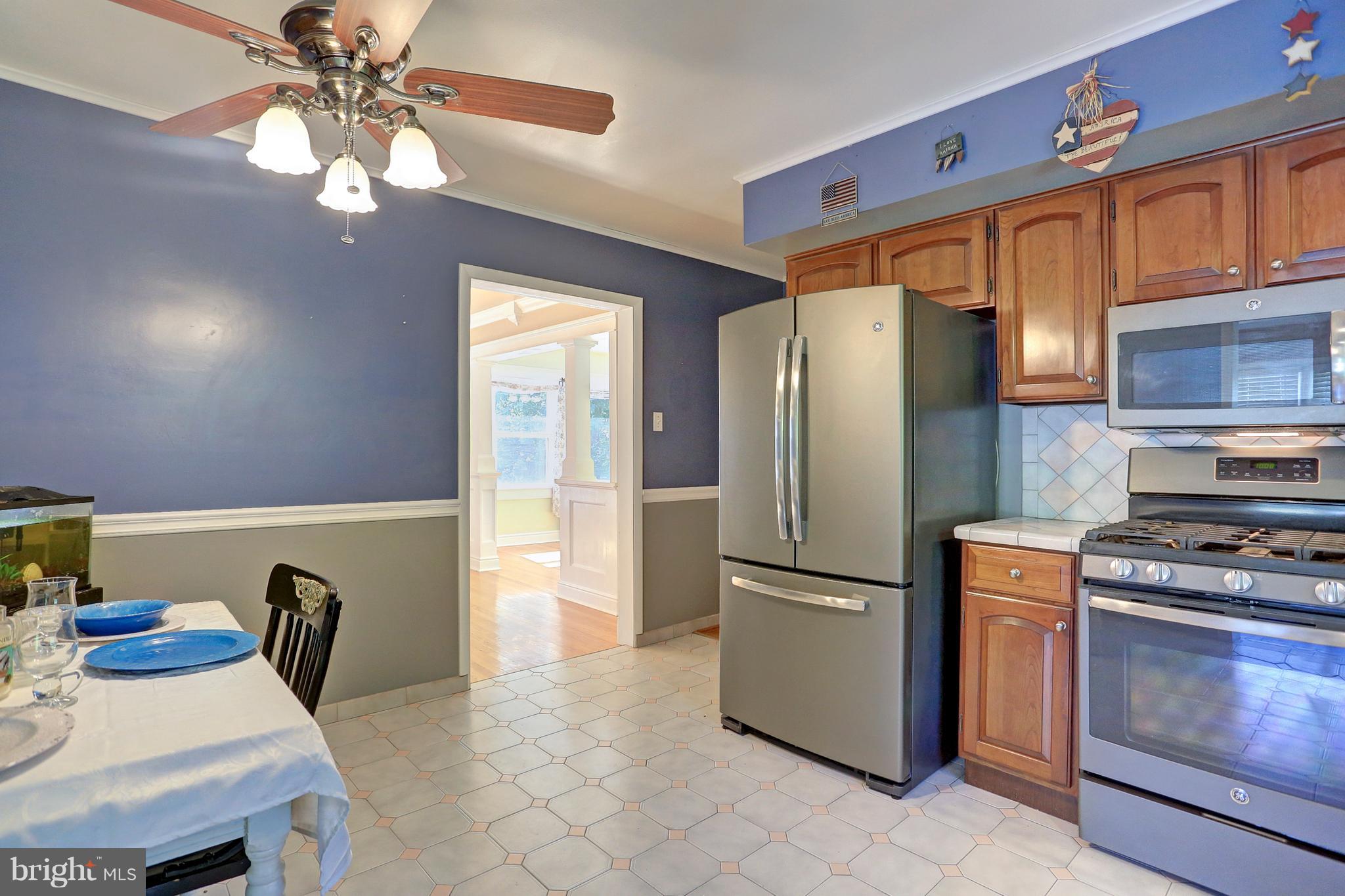 425 Corbin Road York, PA 17403 - Photo 14 of 49 a kitchen with stainless steel appliances granite countertop a refrigerator a stove a sink dishwasher and a dining table with wooden floor