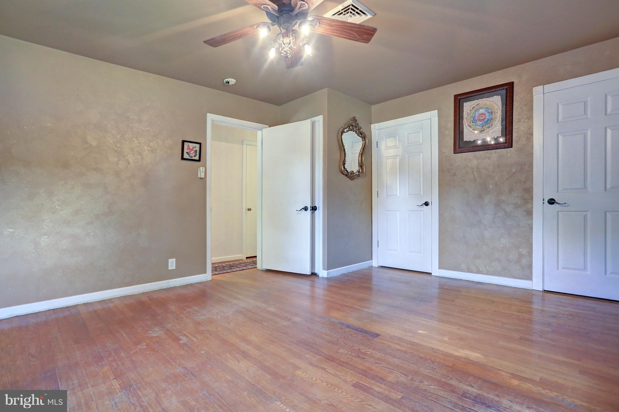 425 Corbin Road York, PA 17403 - Photo 22 of 49 an empty room with wooden floor and a ceiling fan
