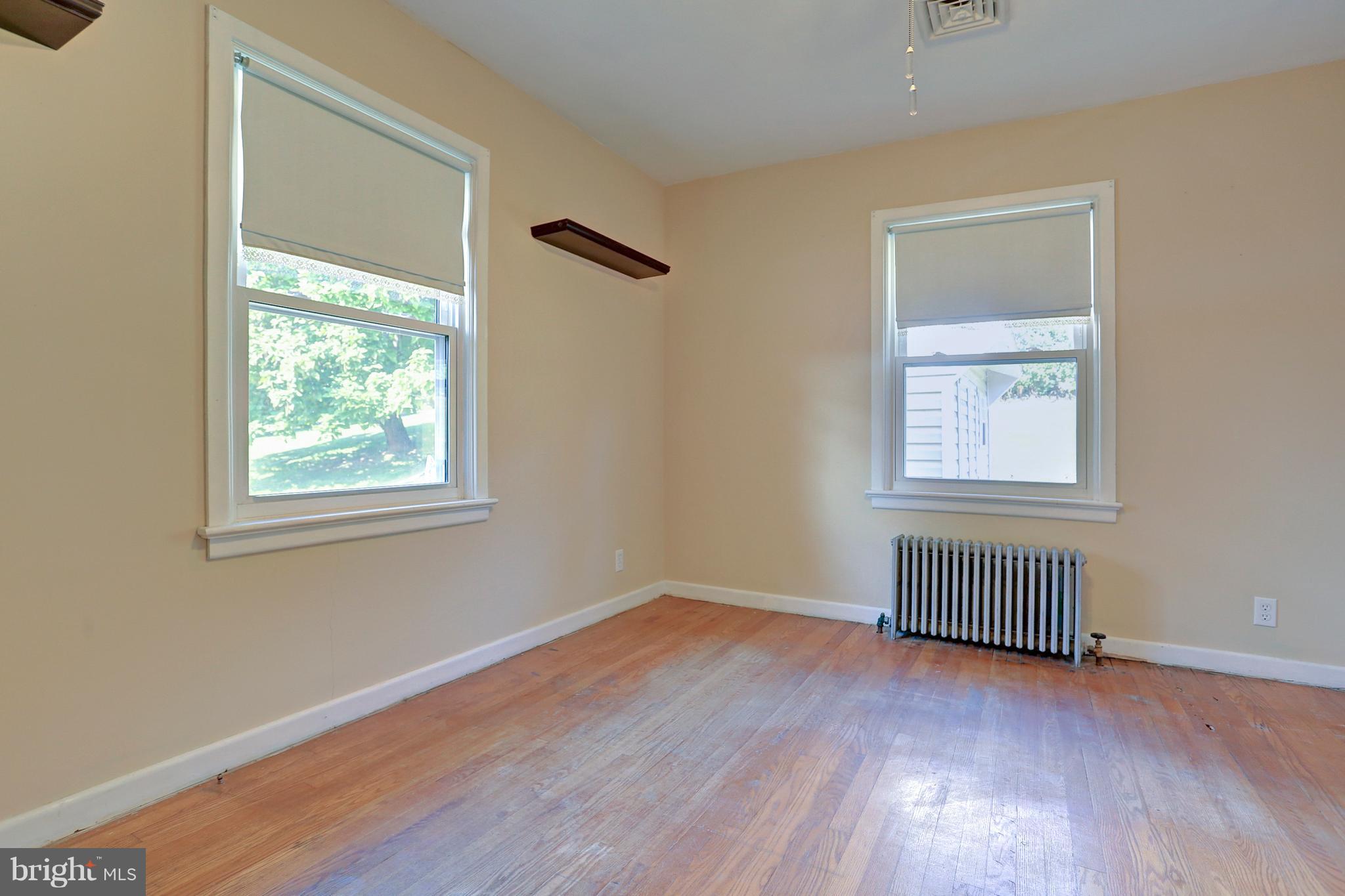 425 Corbin Road York, PA 17403 - Photo 23 of 49 a view of an empty room with wooden floor and a window