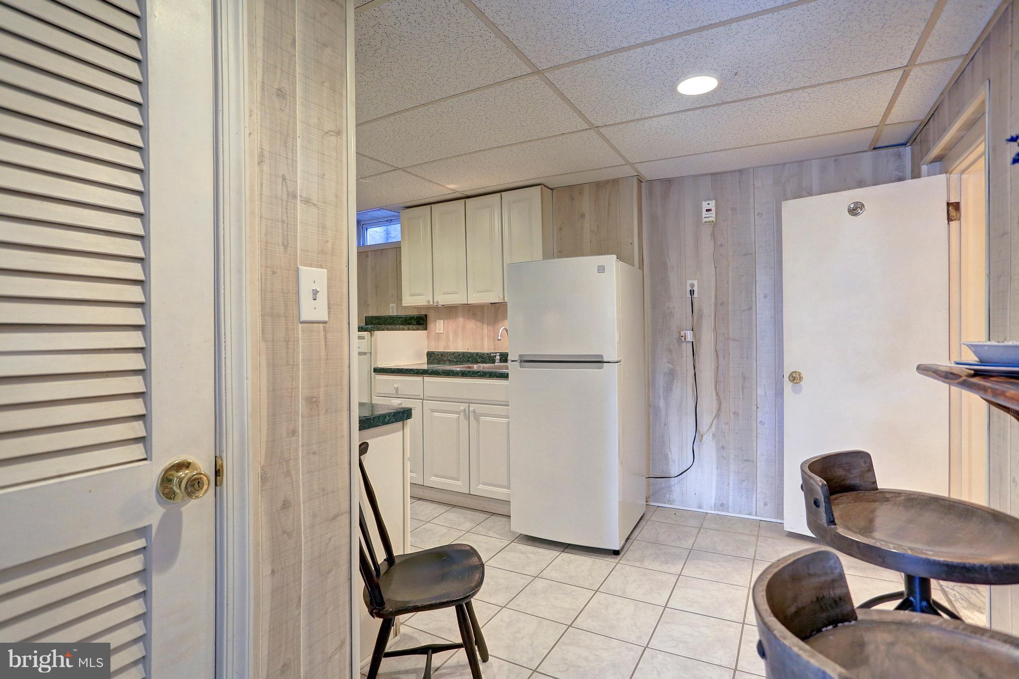 425 Corbin Road York, PA 17403 - Photo 37 of 49 a kitchen with a refrigerator and white cabinets