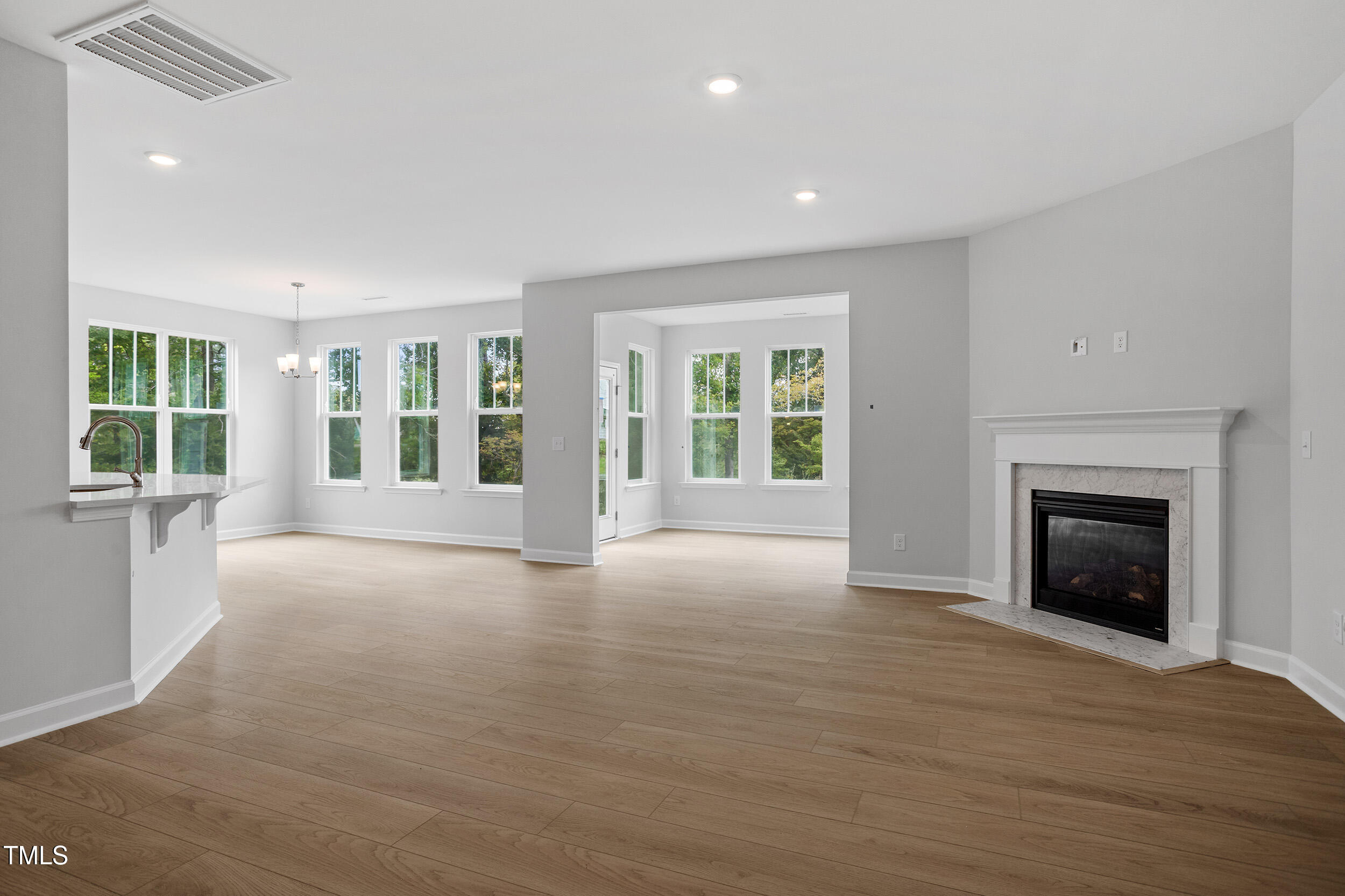 221 Savannah Moss Way, Unit 119 Raleigh, NC 27603 - Photo 10 of 41 a view of an empty room with a window and fireplace
