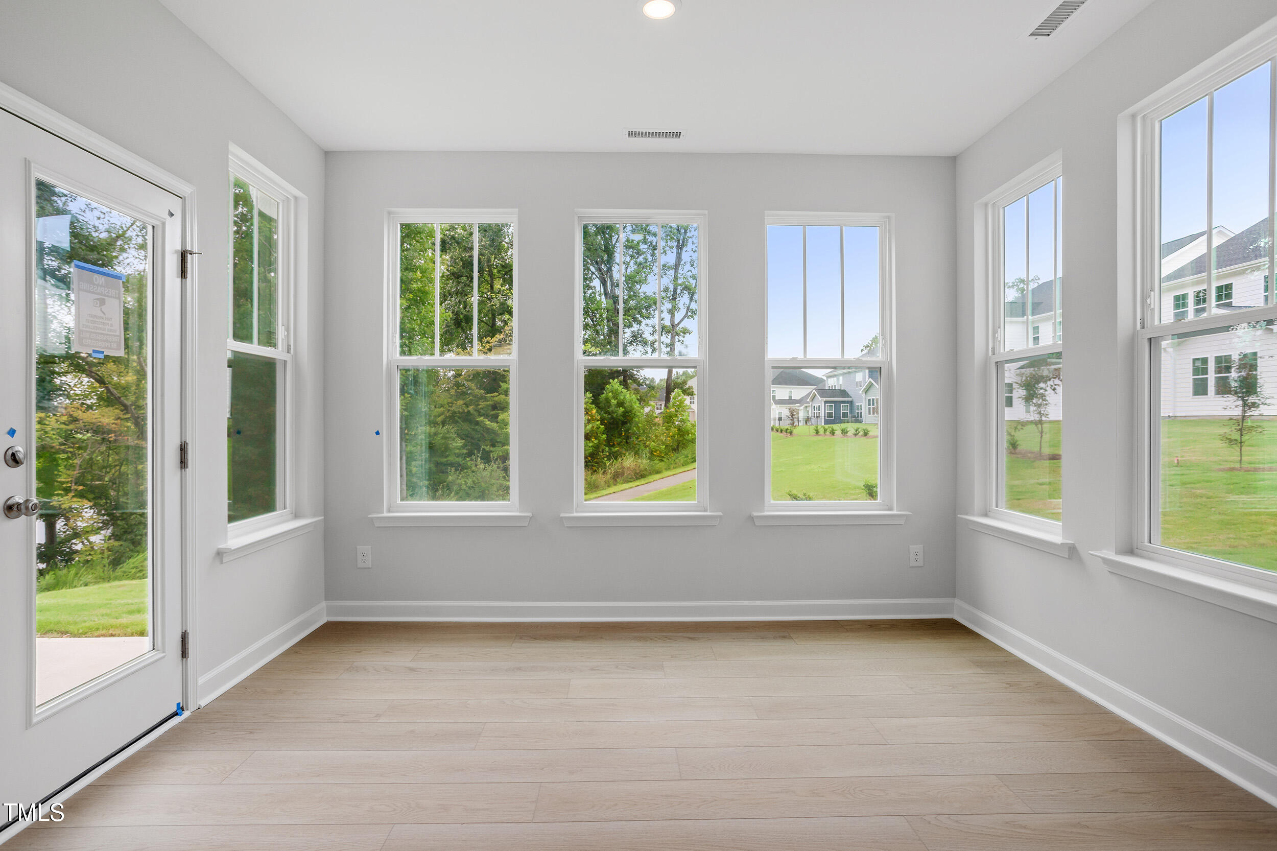 221 Savannah Moss Way, Unit 119 Raleigh, NC 27603 - Photo 14 of 41 a view of an empty room with a window and a kitchen