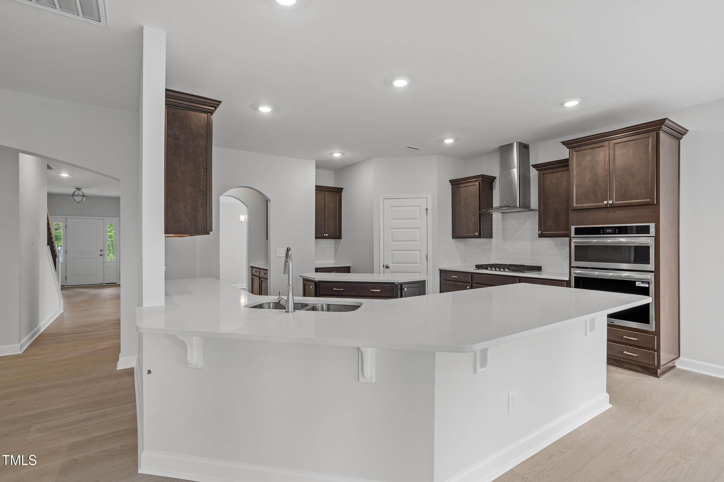 221 Savannah Moss Way, Unit 119 Raleigh, NC 27603 - Photo 15 of 41 a large kitchen with kitchen island a sink stainless steel appliances and cabinets
