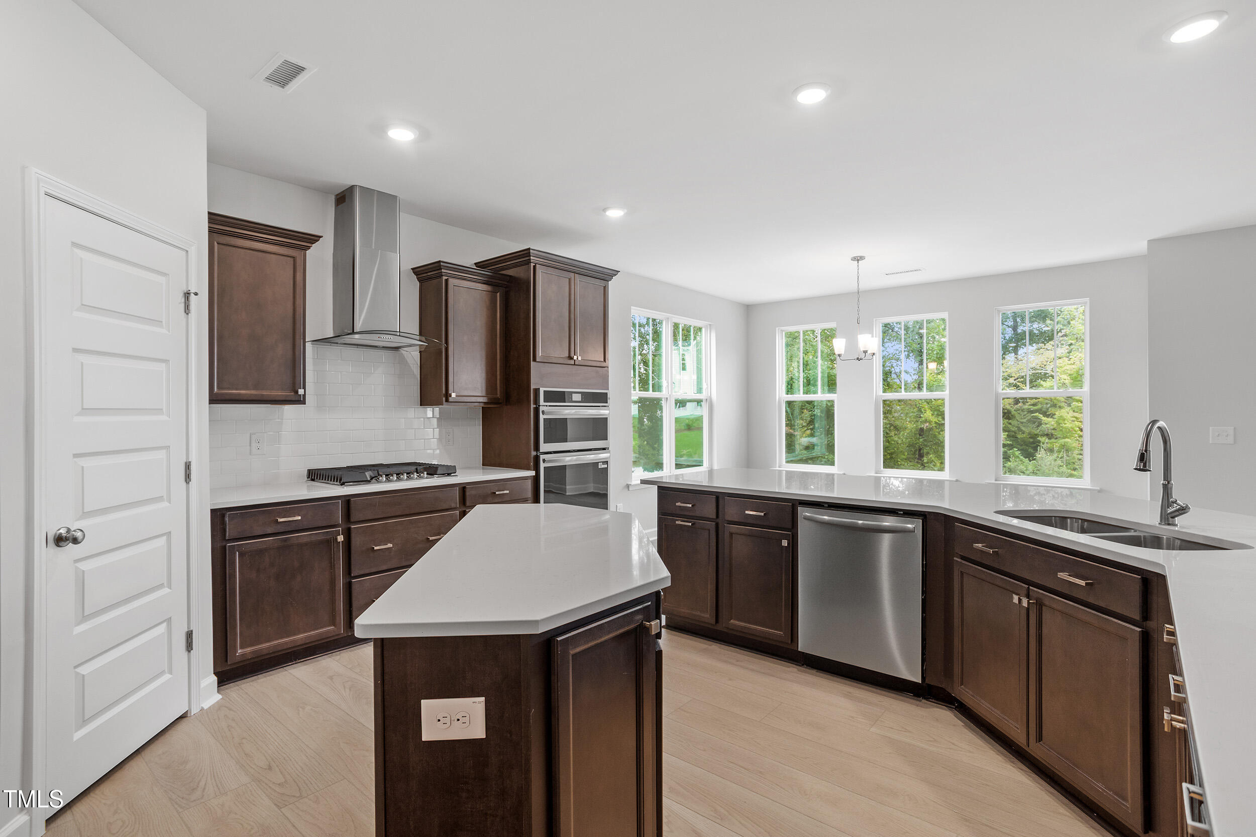 221 Savannah Moss Way, Unit 119 Raleigh, NC 27603 - Photo 18 of 41 a kitchen with stainless steel appliances granite countertop a sink stove and refrigerator