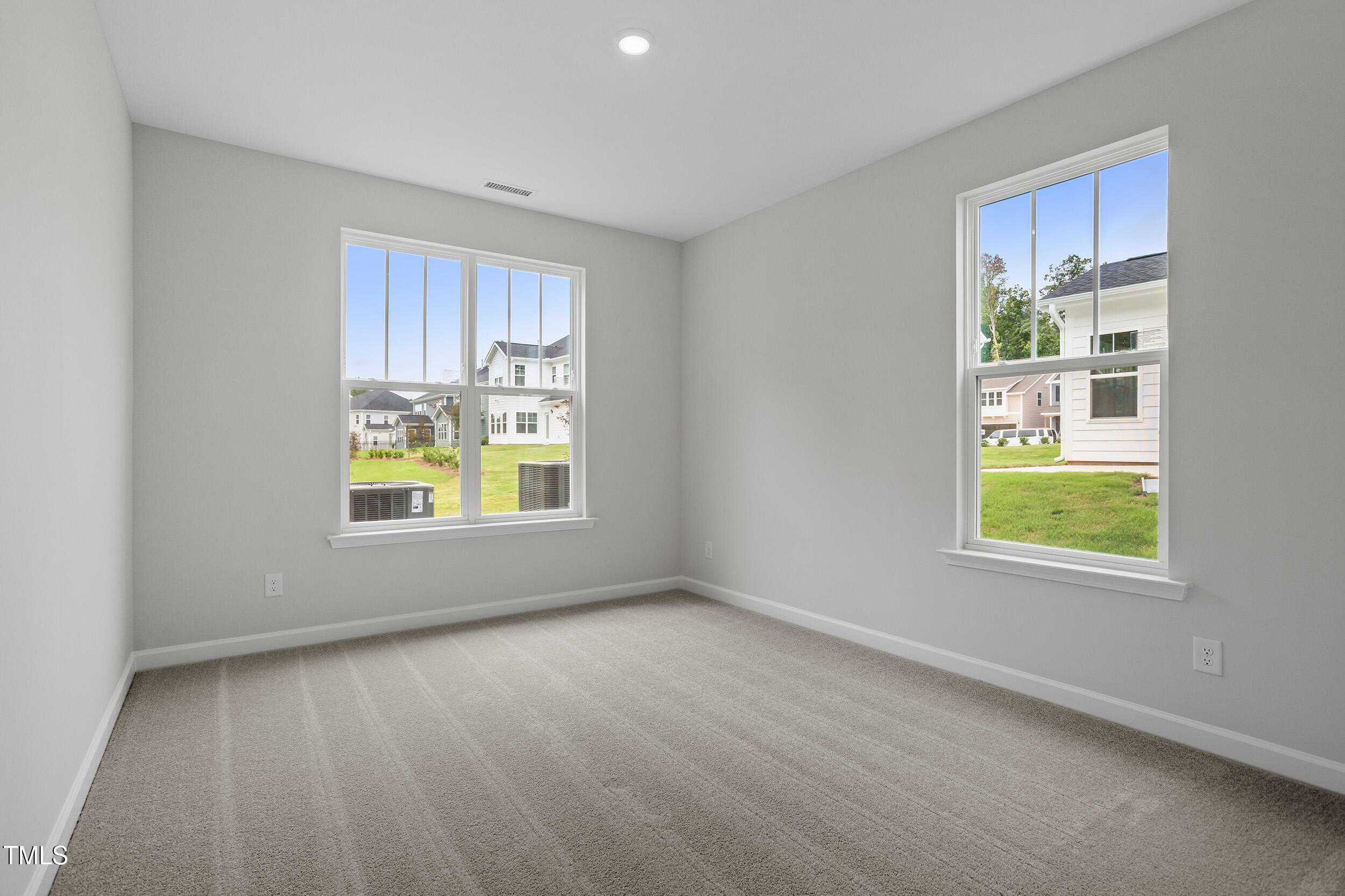 221 Savannah Moss Way, Unit 119 Raleigh, NC 27603 - Photo 20 of 41 an empty room with windows