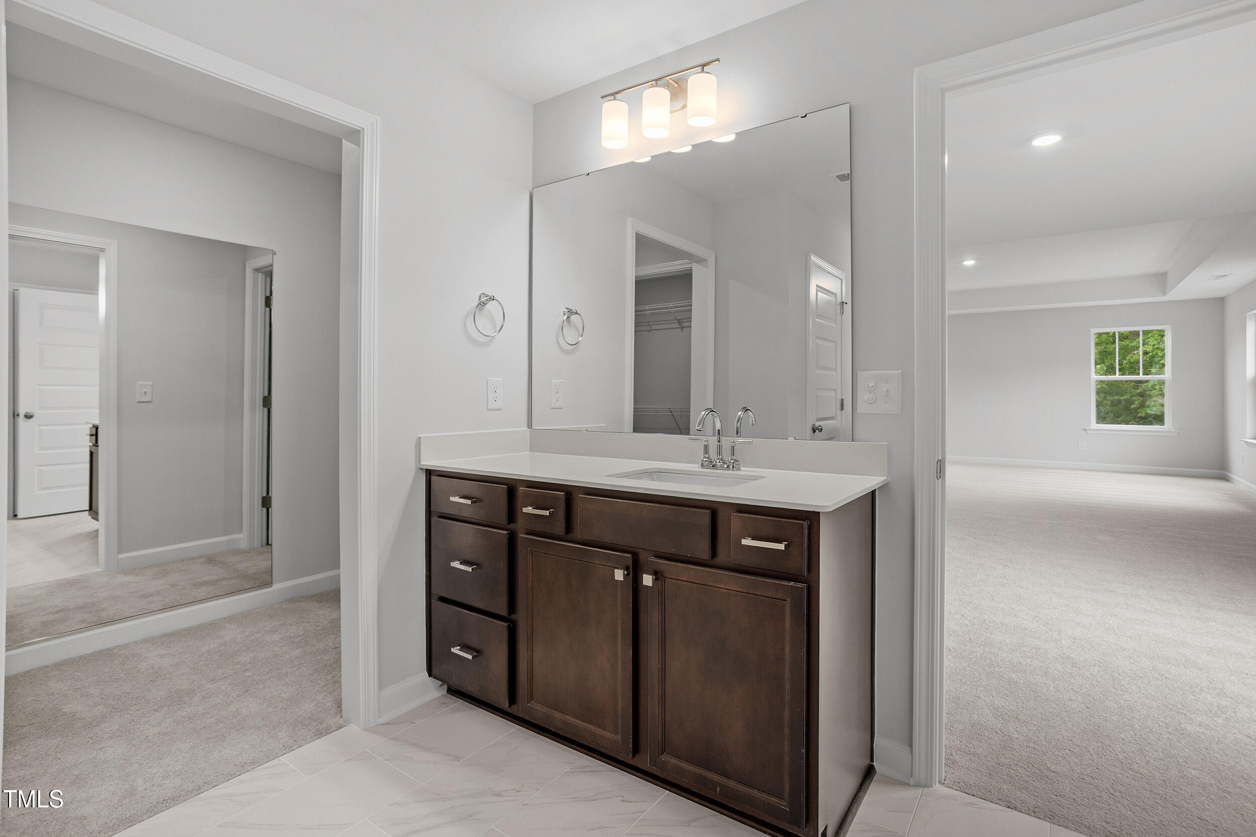 221 Savannah Moss Way, Unit 119 Raleigh, NC 27603 - Photo 27 of 41 a bathroom with a sink double vanity and a mirror