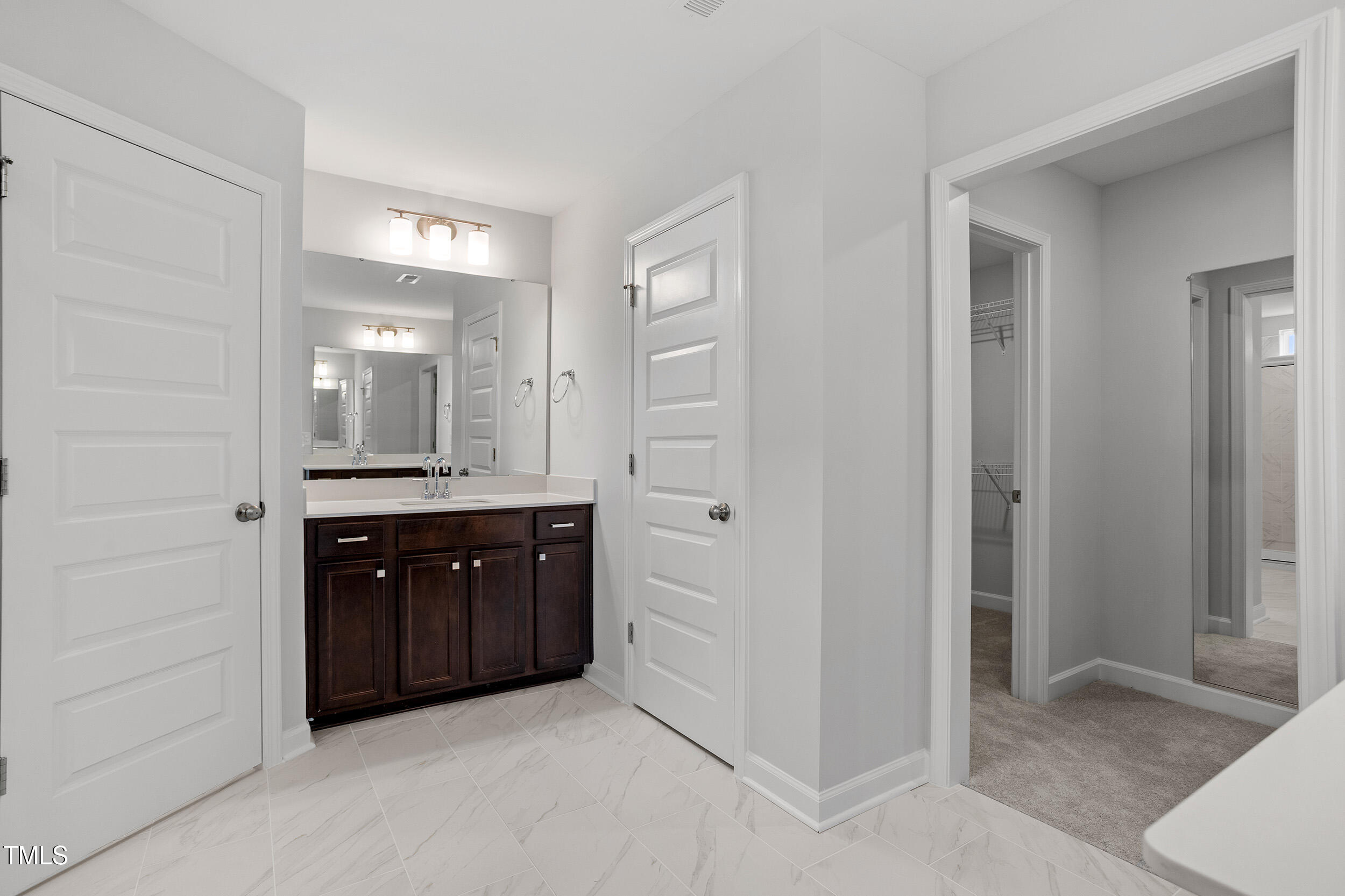221 Savannah Moss Way, Unit 119 Raleigh, NC 27603 - Photo 28 of 41 a spacious bathroom with a double vanity sink and a mirror