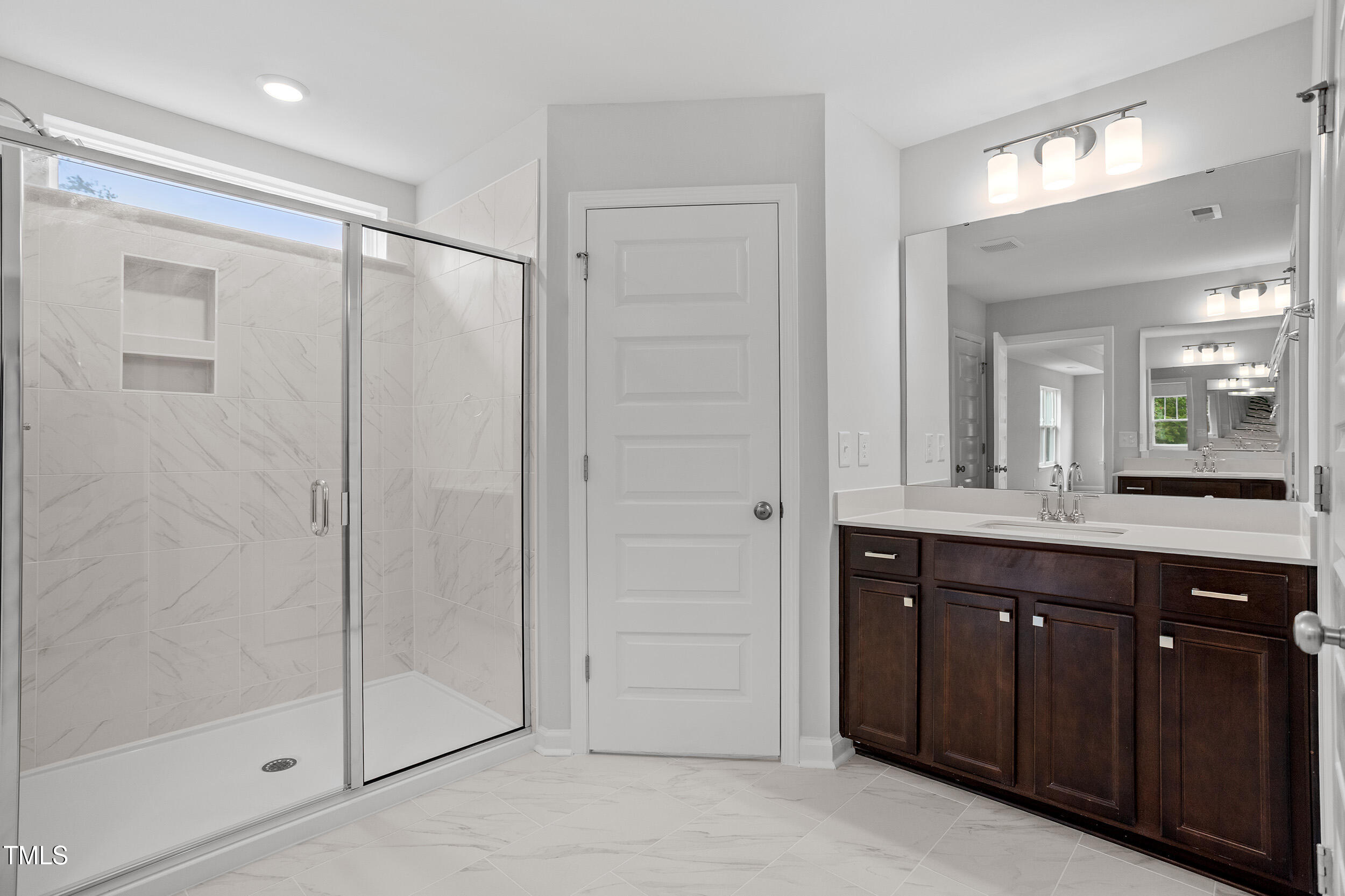 221 Savannah Moss Way, Unit 119 Raleigh, NC 27603 - Photo 29 of 41 a spacious bathroom with a shower and a sink