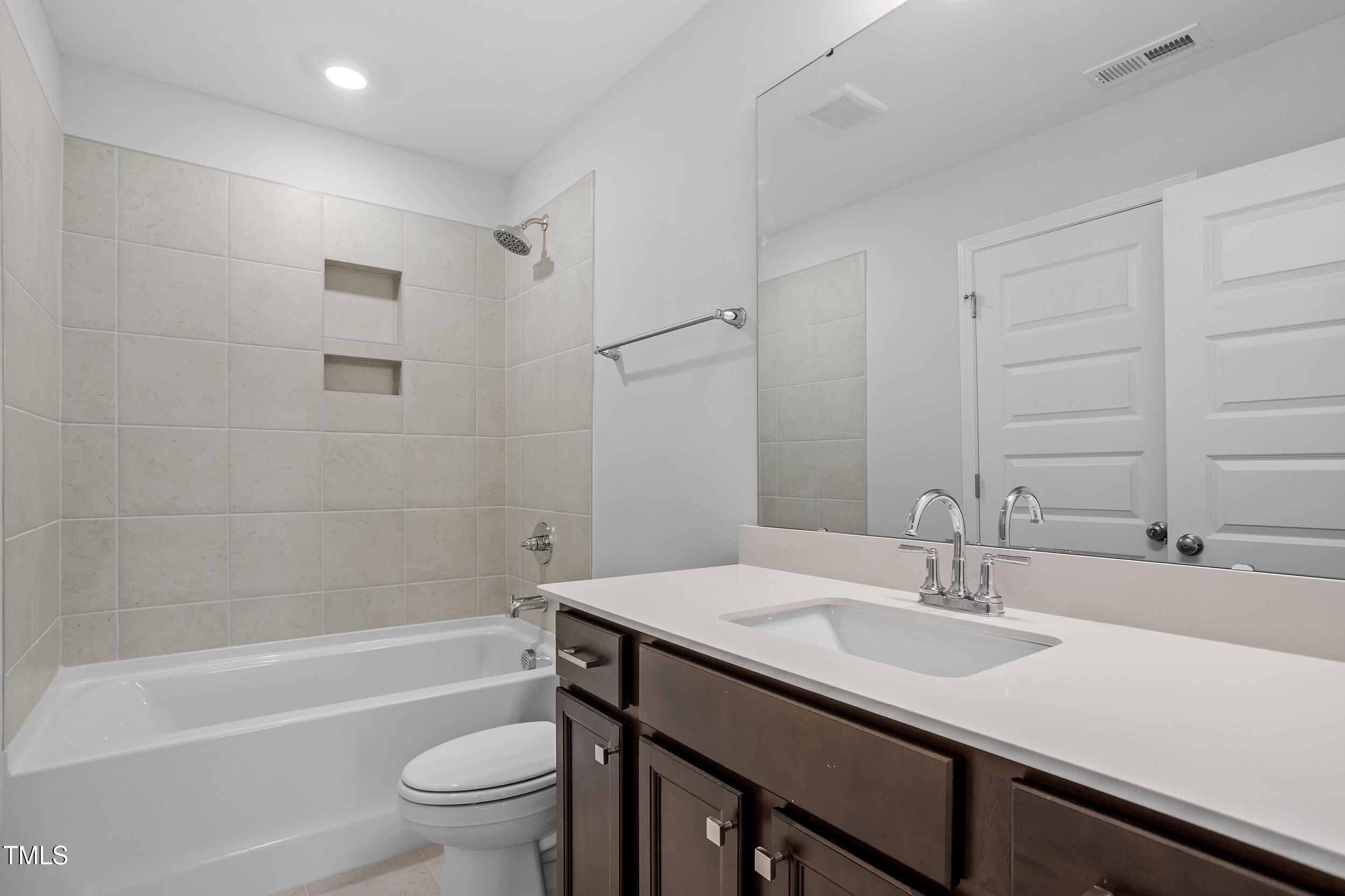 221 Savannah Moss Way, Unit 119 Raleigh, NC 27603 - Photo 32 of 41 a bathroom with a sink and a mirror