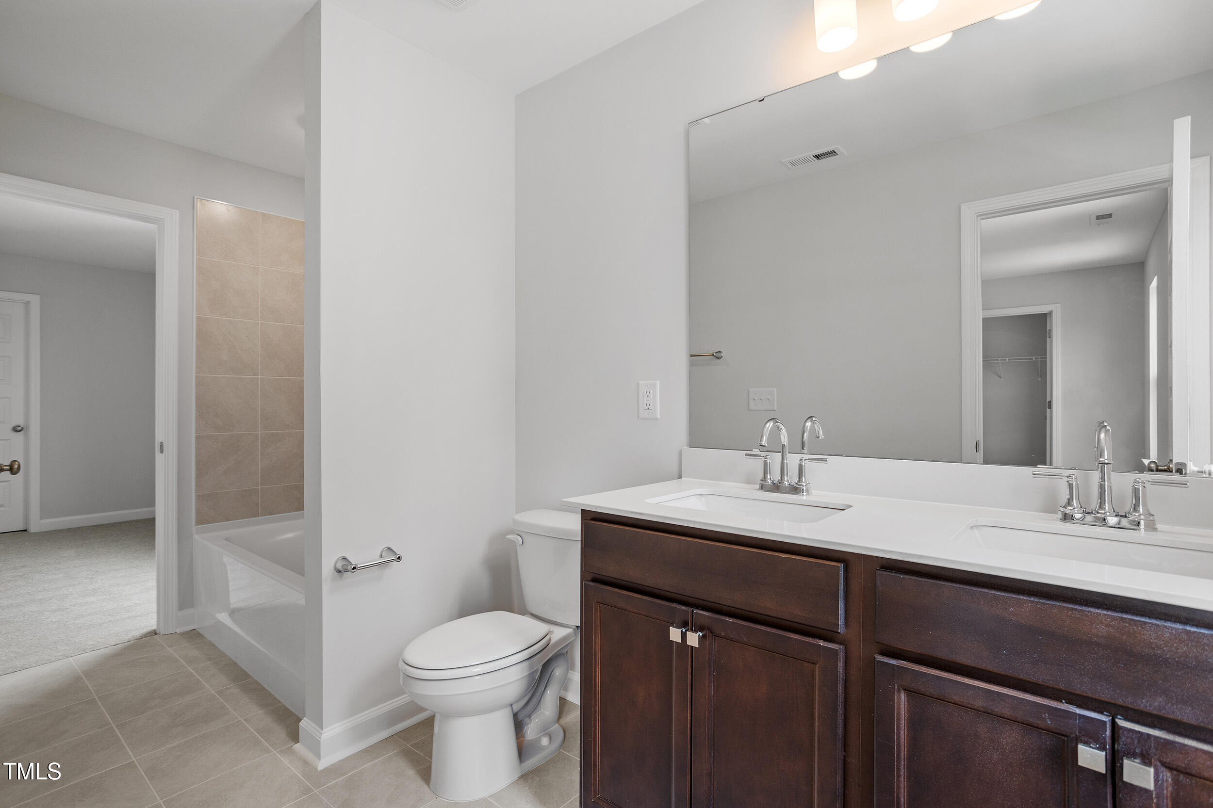 221 Savannah Moss Way, Unit 119 Raleigh, NC 27603 - Photo 35 of 41 a bathroom with a sink a toilet and shower