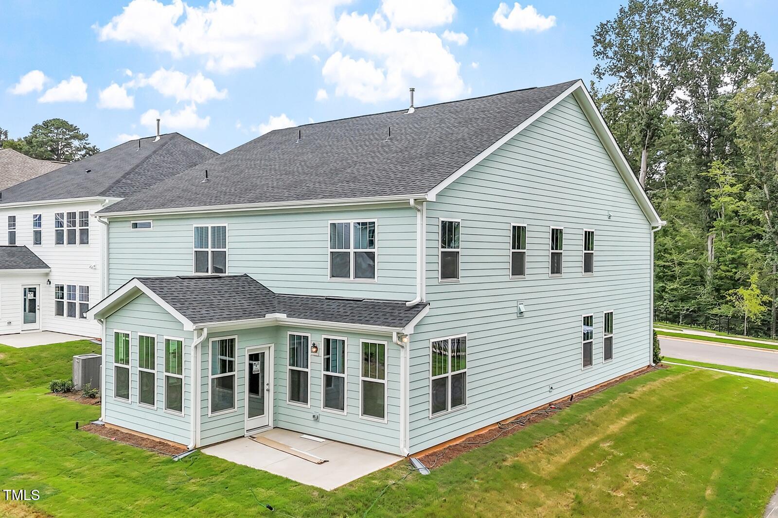 221 Savannah Moss Way, Unit 119 Raleigh, NC 27603 - Photo 5 of 41 a view of a white house with a yard and potted plants
