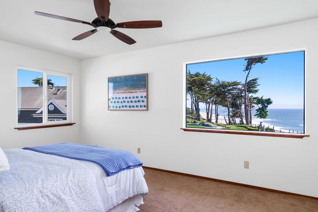 101 Lilly Way La Selva Beach, CA 95076 - Photo 35 of 57 a bedroom with a large bed and a chandelier fan