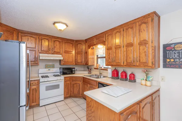 a kitchen with a sink cabinets and window