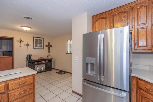 a kitchen with stainless steel appliances a refrigerator and a stove top oven