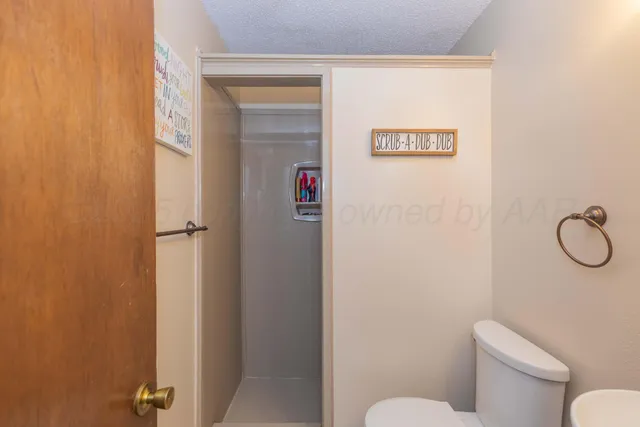 a bathroom with a toilet and a shower