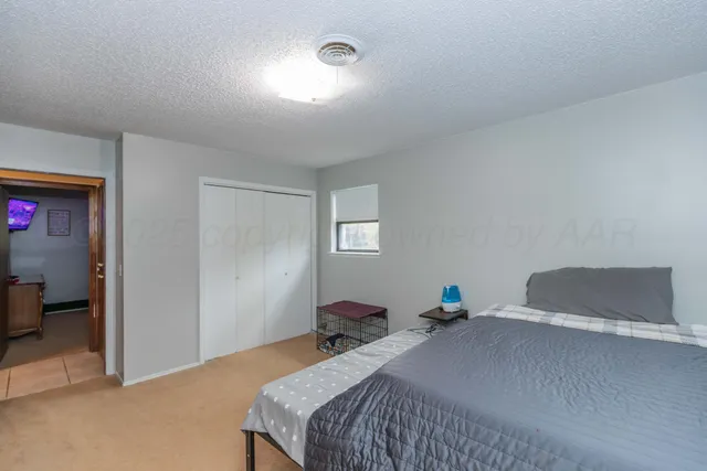 a bedroom with bed and window