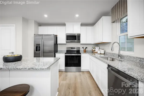 a kitchen with a sink stove and refrigerator