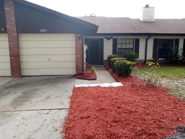 a backyard of a house with barbeque oven and barbeque oven