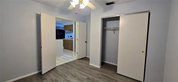 an empty room and wooden floor with a bathroom
